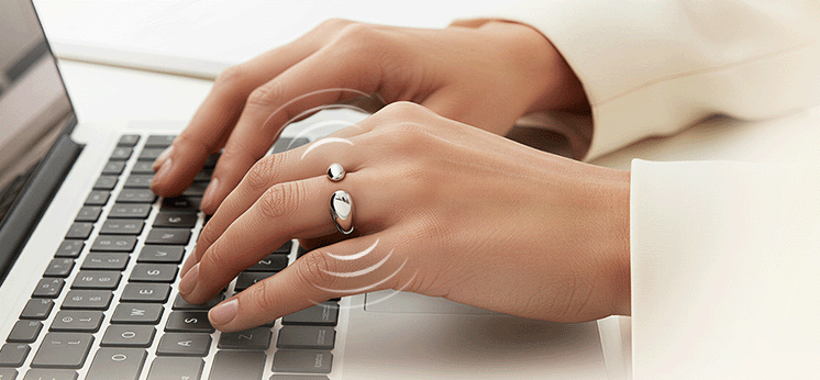 Catellect smart ring on hand while typing for pet presence notification